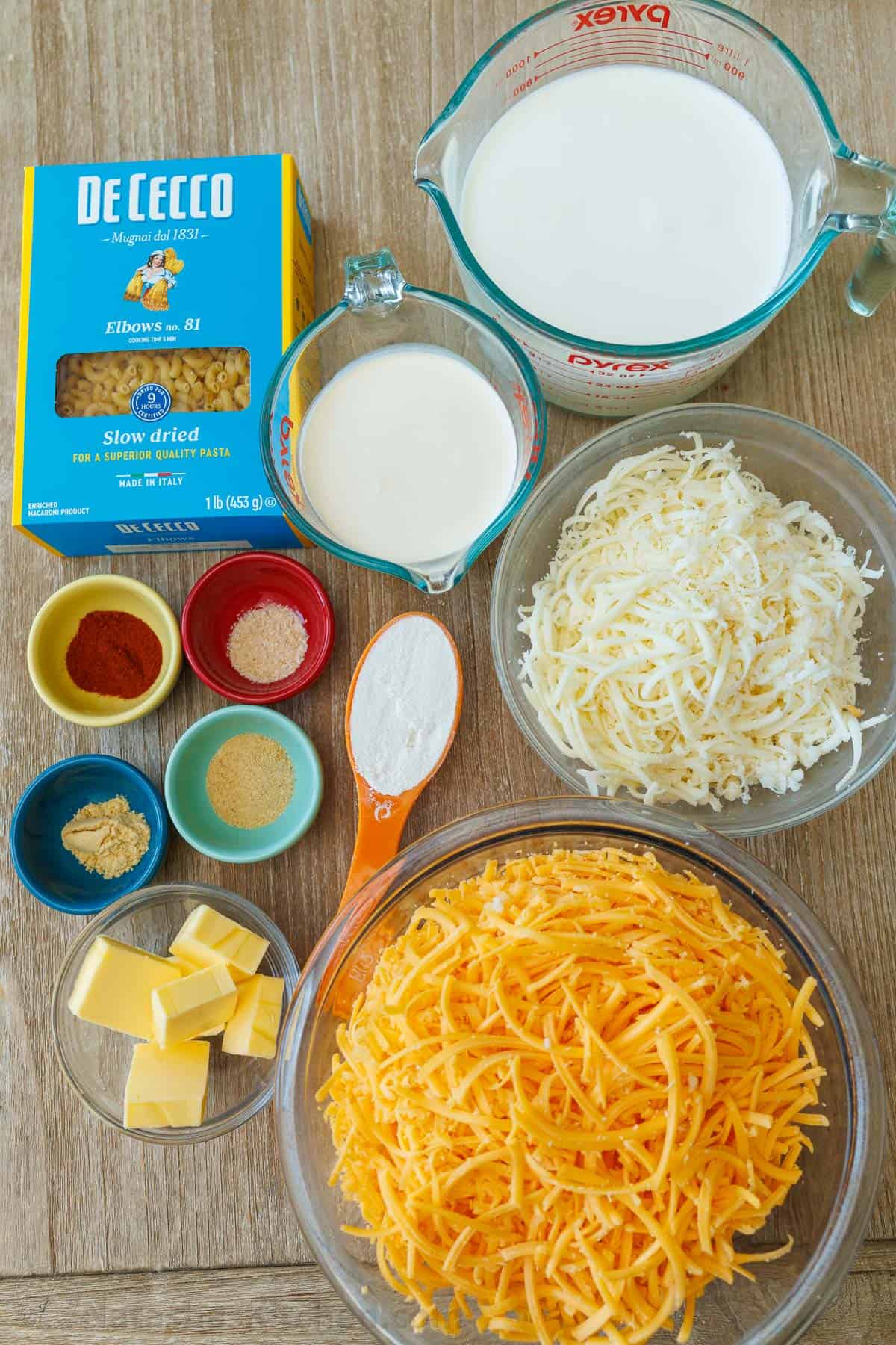My Easy homemade Baked Mac and Cheese swaps the breadcrumbs for a crowd-pleasing cheese topping. It's perfectly gooey and easy to make. Ingredients for Baked Cheesy Pasta with elbows, whole milk, heavy cream, mozzarella, cheddar, paprika, garlic powder, onion powder, flour, mustard powder, and butter