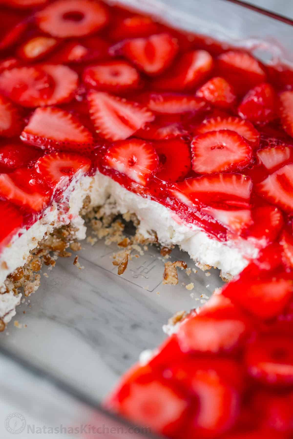 A slice cut out of a dish of strawberry pretzel salad